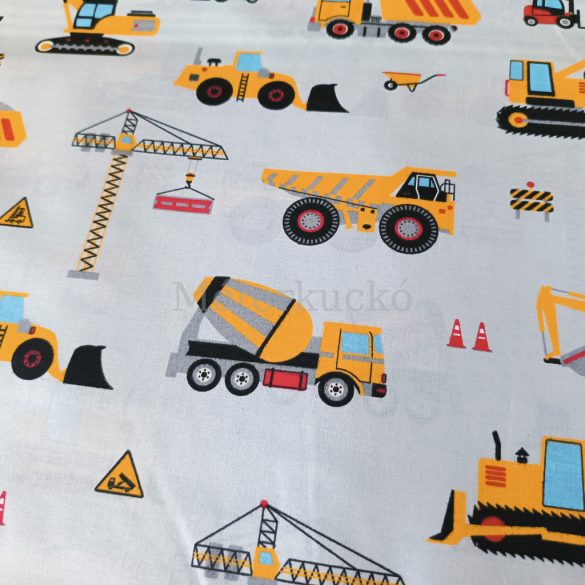 Halványkék alapon sárga munkagép mintás pamutvászon 0,9fm-es darab